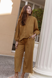 A model wearing the Rio Lyocell Relaxed Pant in colour Tan, from the front, showing the whole outfit