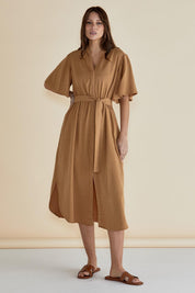 A model wearing the Dresden Lyocell Dress in colour Tan, from the front, showing the whole outfit