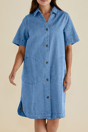 A model wearing the Dawson Denim Dress in colour Midwash (Blue), from the front, cropped image