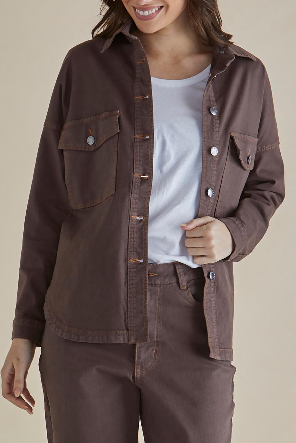 A model wearing the Cherry Denim Shirt in colour Coco, from the front, cropped image