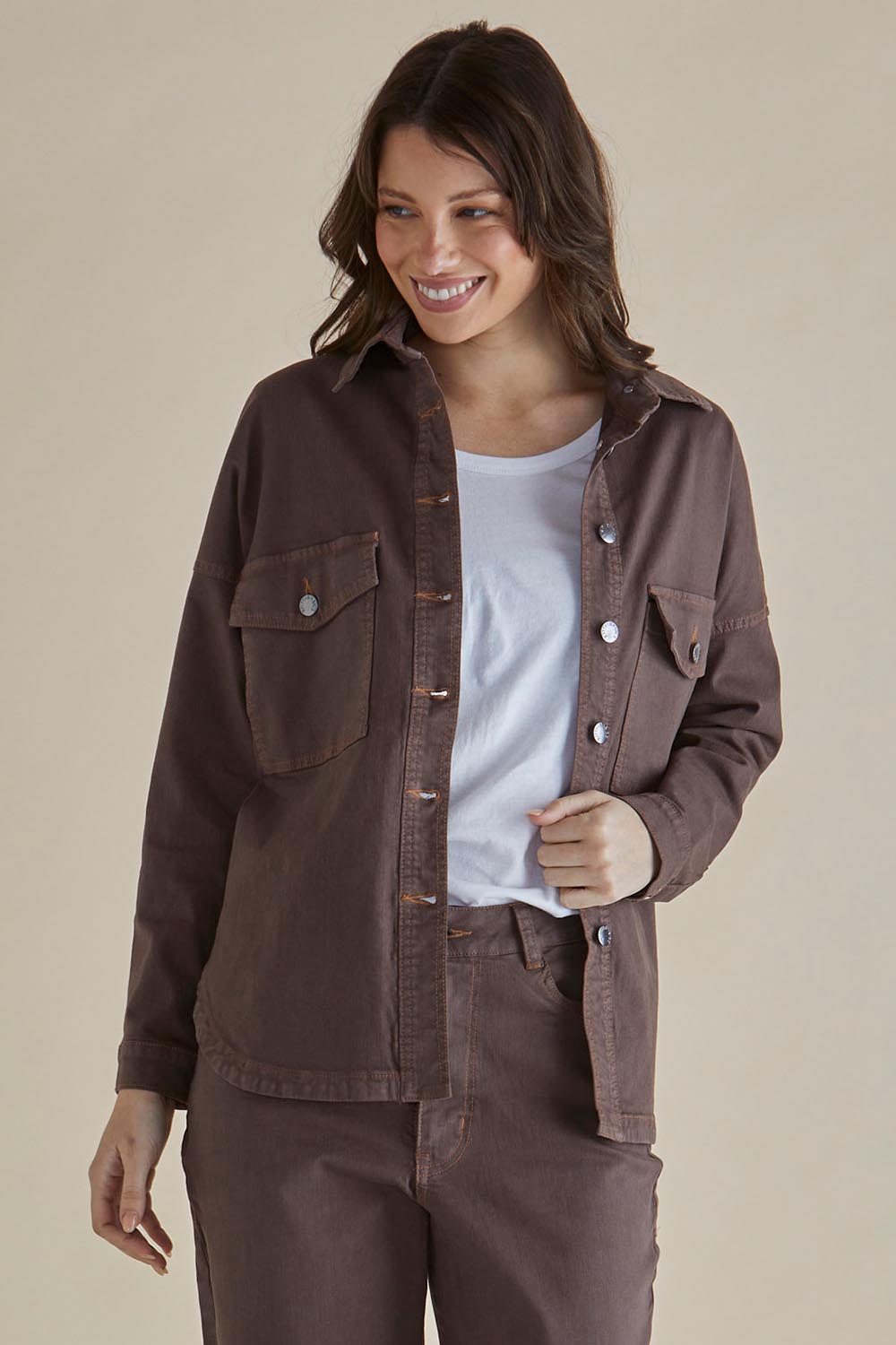 A model wearing the Cherry Denim Shirt in colour Coco, from the front, cropped image