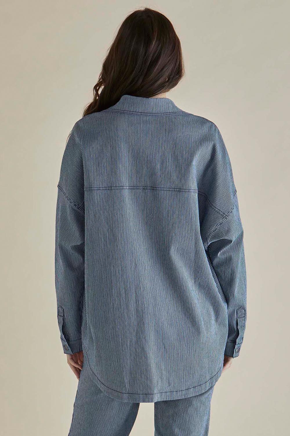 A model wearing the Cherry Denim Shirt in colour Pinstripe (Blue), from the back