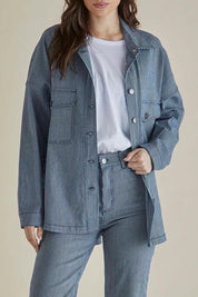 A model wearing the Cherry Denim Shirt in colour Pinstripe (Blue), from the front, cropped image