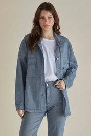 A model wearing the Cherry Denim Shirt in colour Pinstripe (Blue), from the front, cropped image