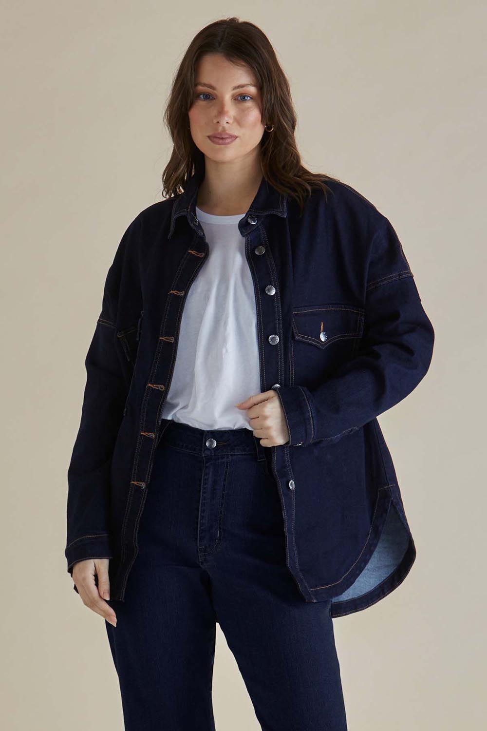 A model wearing the Cherry Denim Shirt in colour Smokeink (Blue), from the front, cropped image