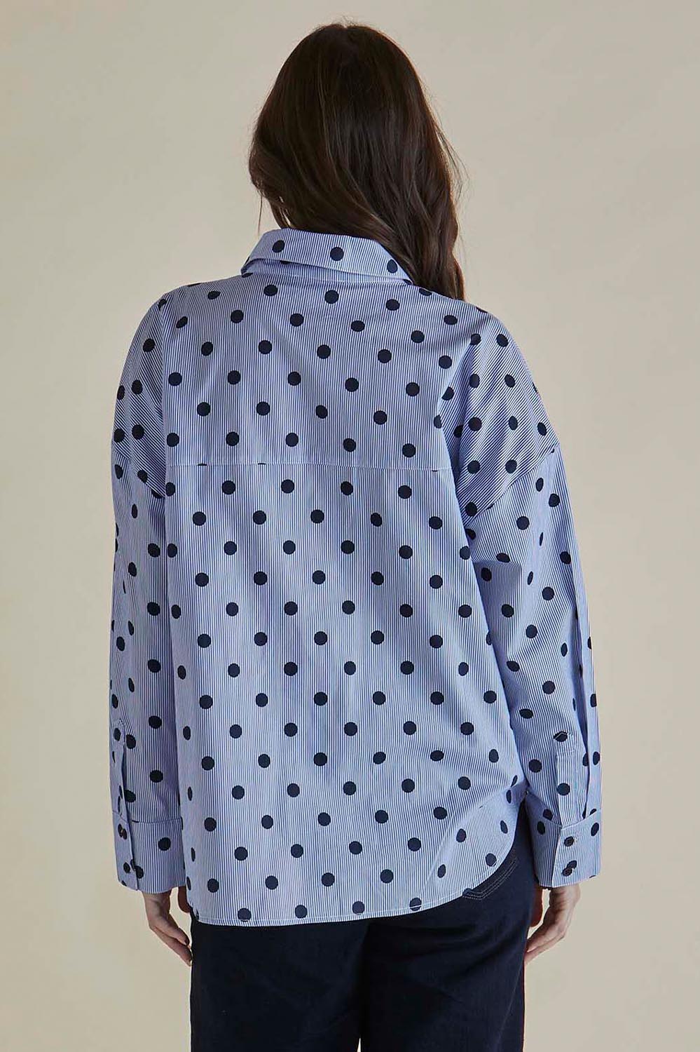 A model wearing the Sage Cotton Shirt in colour Polkadot (Blue), from the back