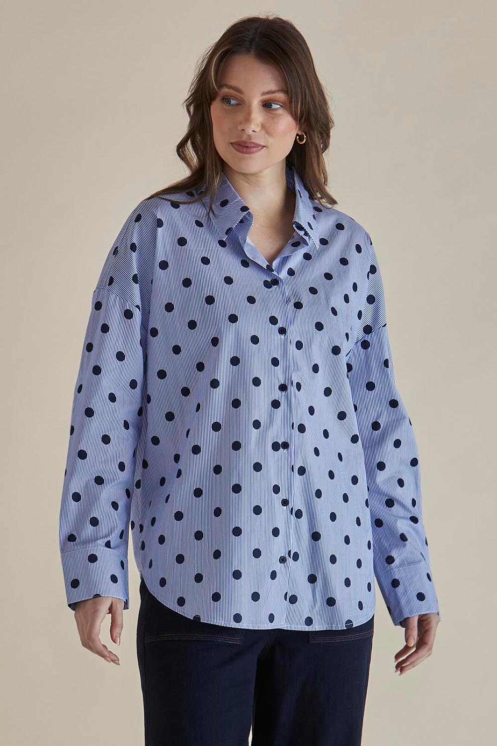A model wearing the Sage Cotton Shirt in colour Polkadot (Blue), from the front, cropped image