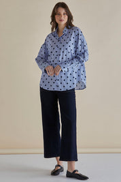 A model wearing the Sage Cotton Shirt in colour Polkadot (Blue), from the front, showing the whole outfit
