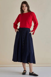 A model wearing the Lola Lyocell Skirt in colour Drkvintage (Blue), from the front, showing the whole outfit