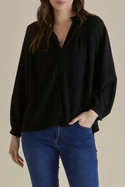 A model wearing the Marie Blouse in colour Black (Black), from the front, cropped image