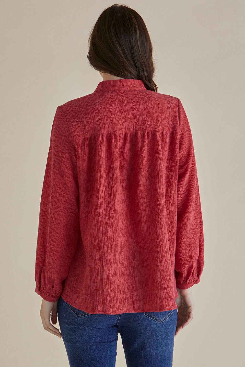 A model wearing the Marie Blouse in colour DustyPink (Pink), from the back