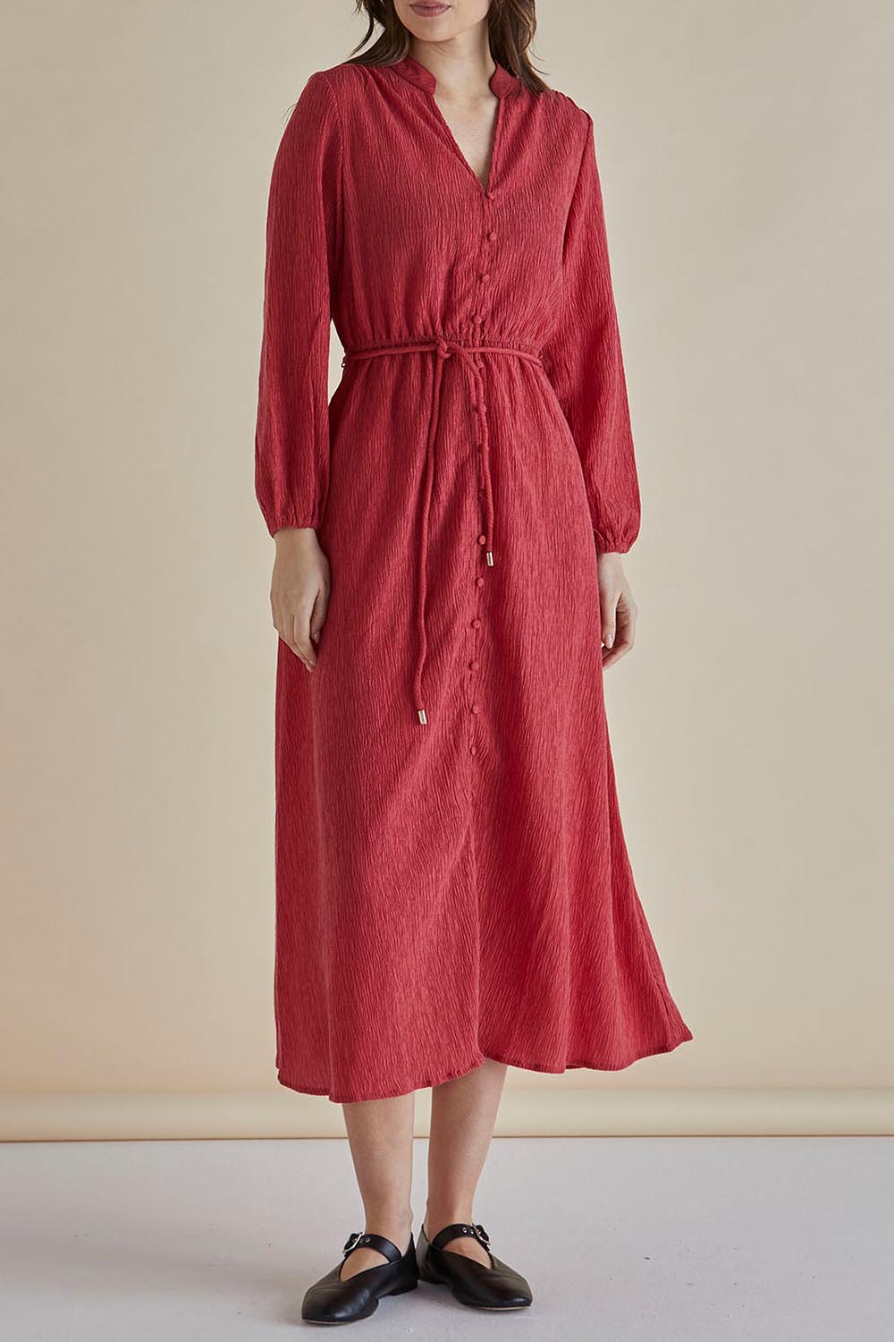 A model wearing the Anette Dress in colour Dustypink (Pink), from the front, cropped image