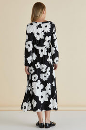 A model wearing the Aries Dress in colour Floral (Black), from the back
