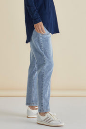 A model wearing the Haven Straight Leg Jean in colour Lightblue (Blue), from the front, cropped image