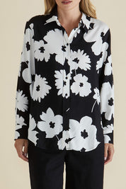 A model wearing the Rosie Shirt in colour Floral (Black), from the front, cropped image