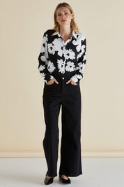 A model wearing the Rosie Shirt in colour Floral (Black), from the front, showing the whole outfit