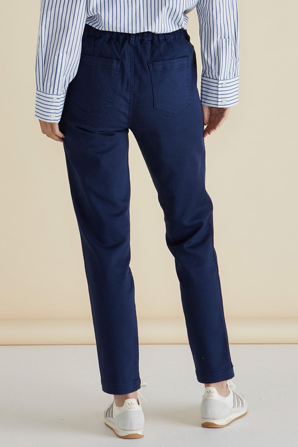 A model wearing the Carey Cotton Blend Chino Jogger in colour Navy (Blue), from the back