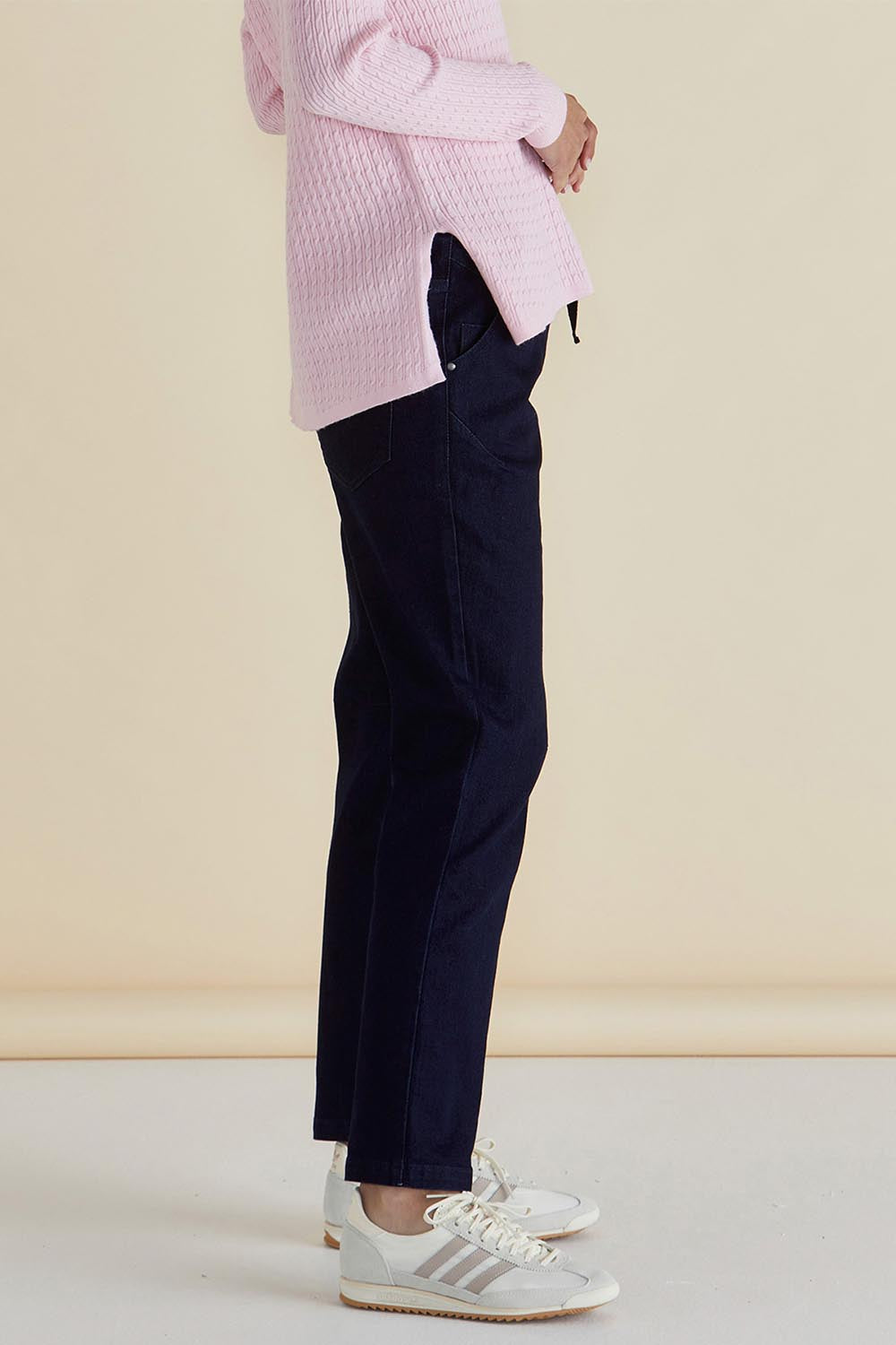 A model wearing the Harlow Denim Jogger in colour Indigo (Blue), from the front, cropped image