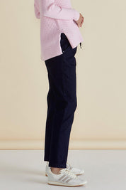 A model wearing the Harlow Denim Jogger in colour Indigo (Blue), from the front, cropped image