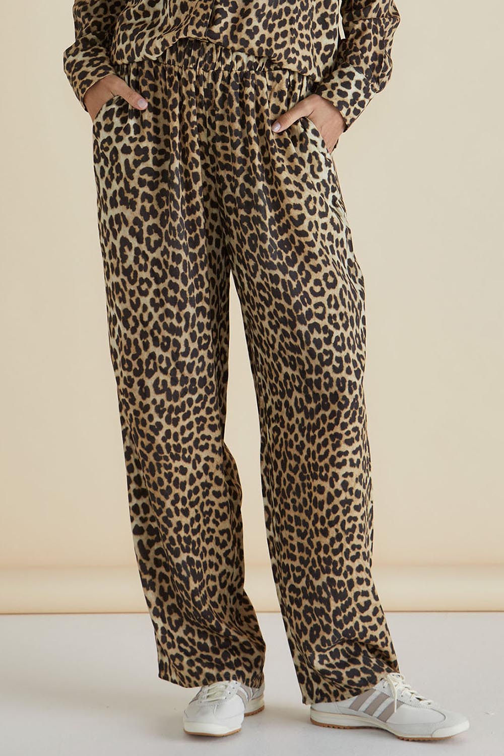 A model wearing the Lexi Pant in colour Leopard, from the front, cropped image