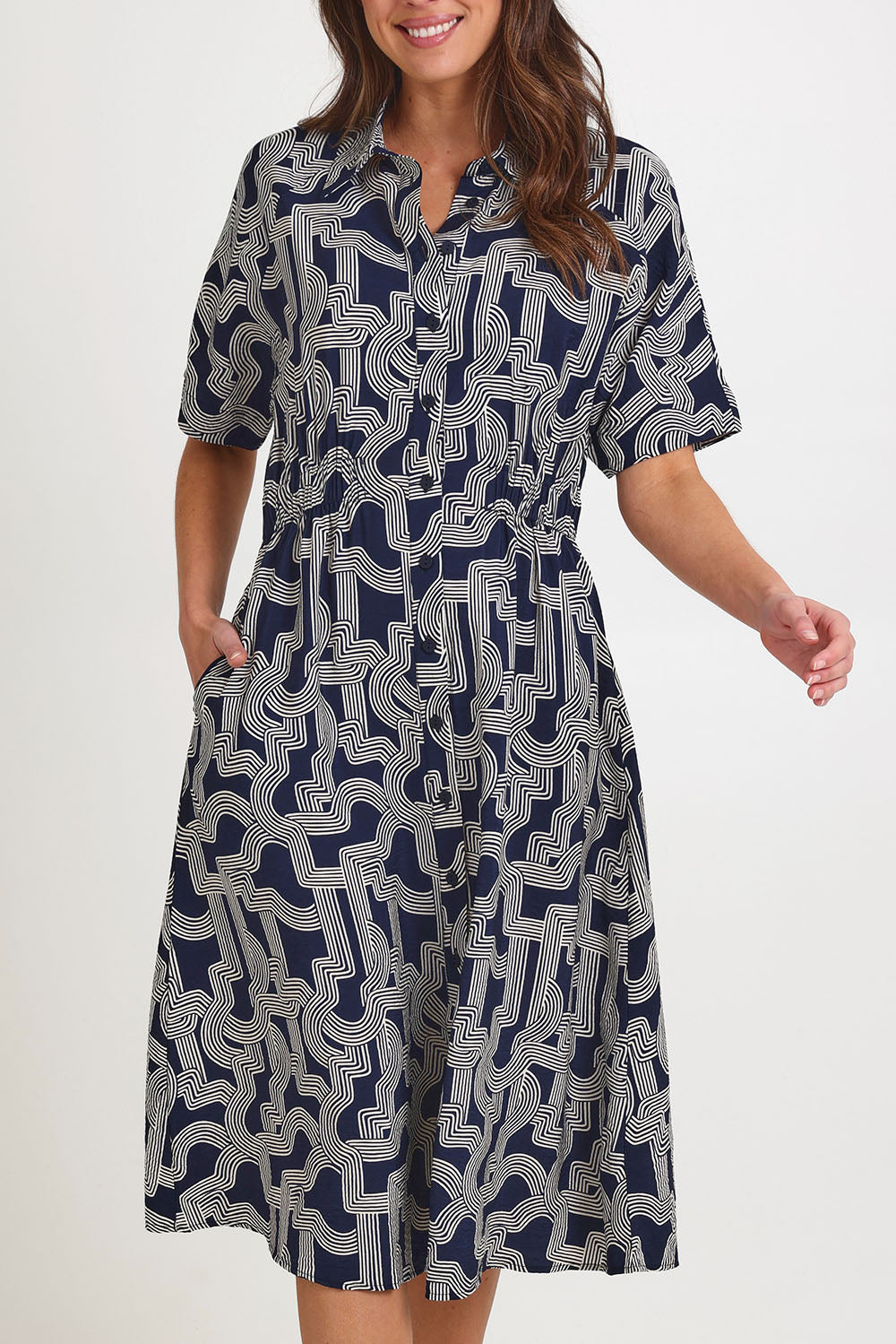 Model Madeline wearing size 10 of the Skye Dress in colour Navygeo (Blue), from the front, cropped image