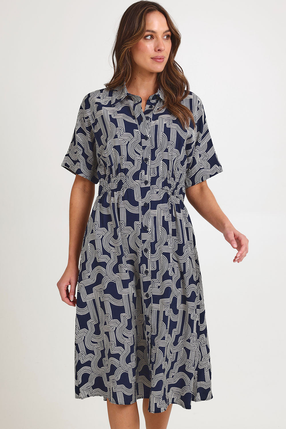 Model Madeline wearing size 10 of the Skye Dress in colour Navygeo (Blue), from the front, cropped image