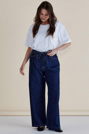 A model wearing the Goldie Jeans in colour Darkblue (Blue), from the front, showing the whole outfit