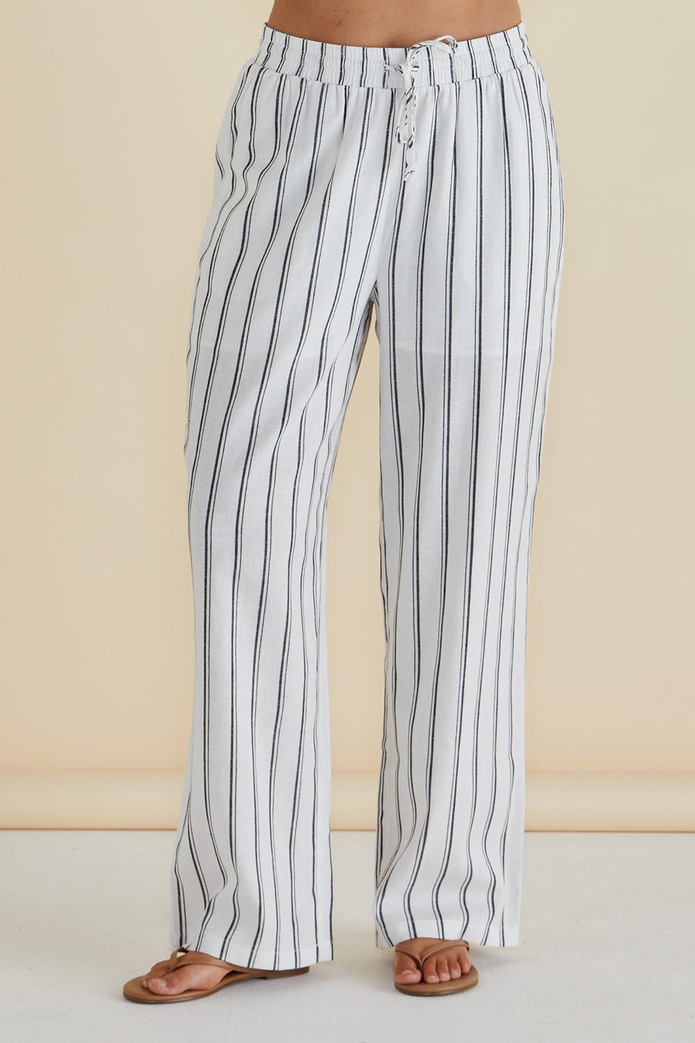A model wearing the Zaza Relax Pant in colour Blkwhite (White), from the front, cropped image