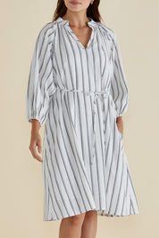 A model wearing the Jenna Dress in colour Blkwhite (White), from the front, cropped image