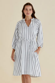 A model wearing the Jenna Dress in colour Blkwhite (White), from the front, cropped image