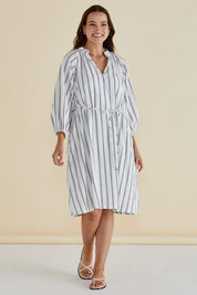 A model wearing the Jenna Dress in colour Blkwhite (White), from the front, showing the whole outfit