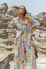 A model wearing the Mills Shirt in colour Paradise, from the front, showing the whole outfit