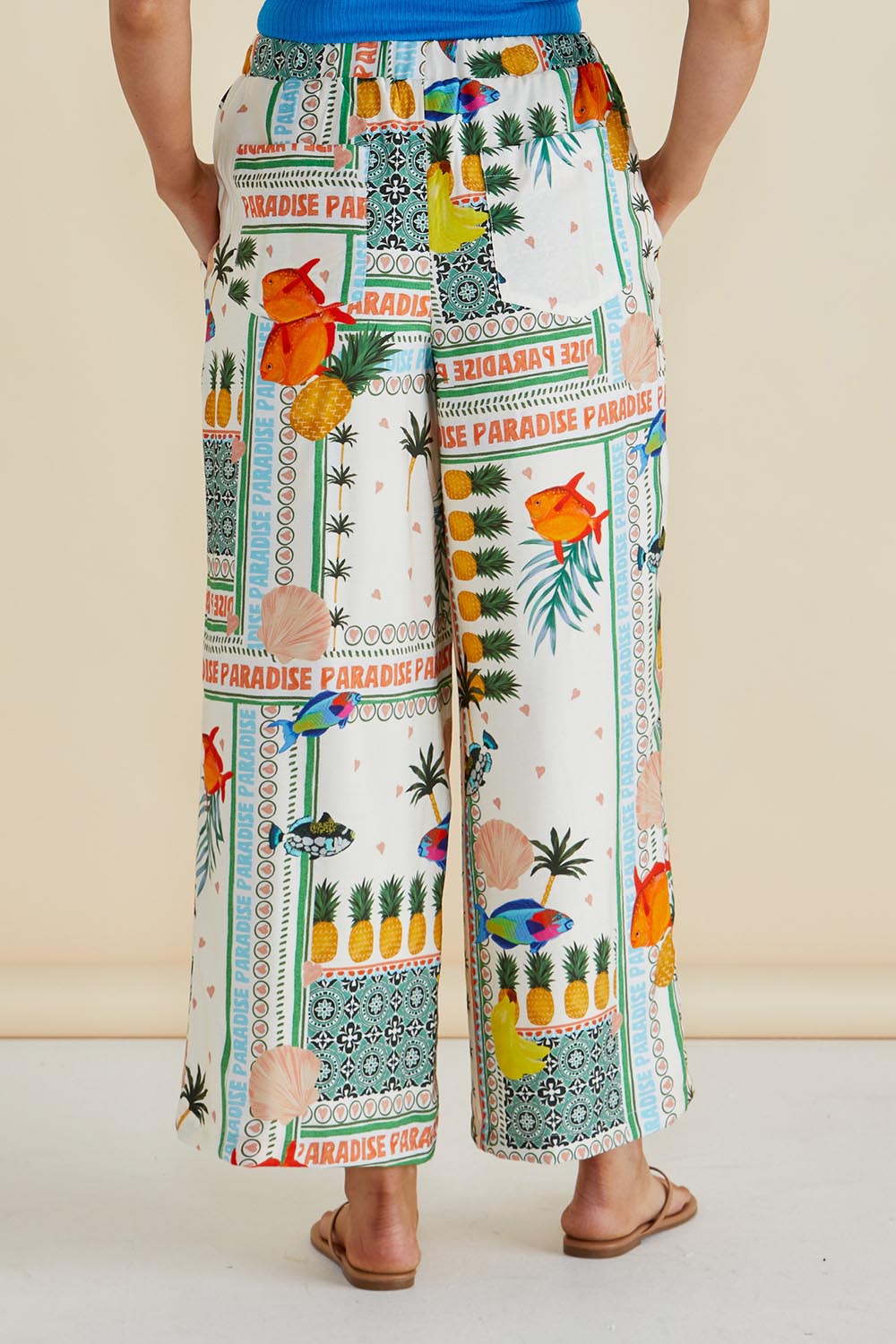 A model wearing the Sable Wide Leg Pant in colour Paradise, from the back