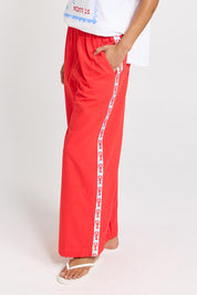 Model Genericm wearing size sample of the Sable Wide Leg Pant – Red in colour Red, from an angle