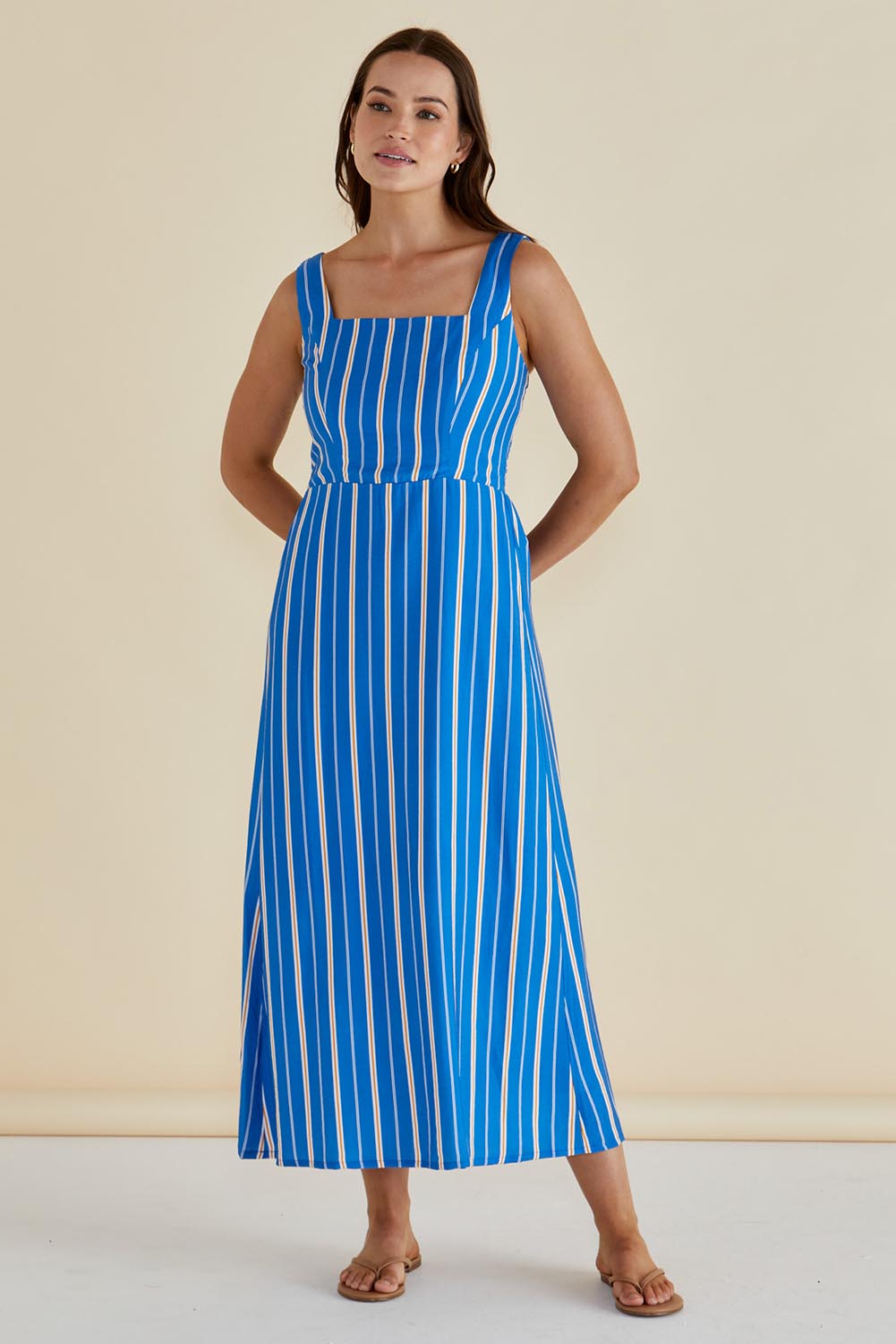 A model wearing the Tegan Midi Dress in colour Blue (Blue), from the front, showing the whole outfit