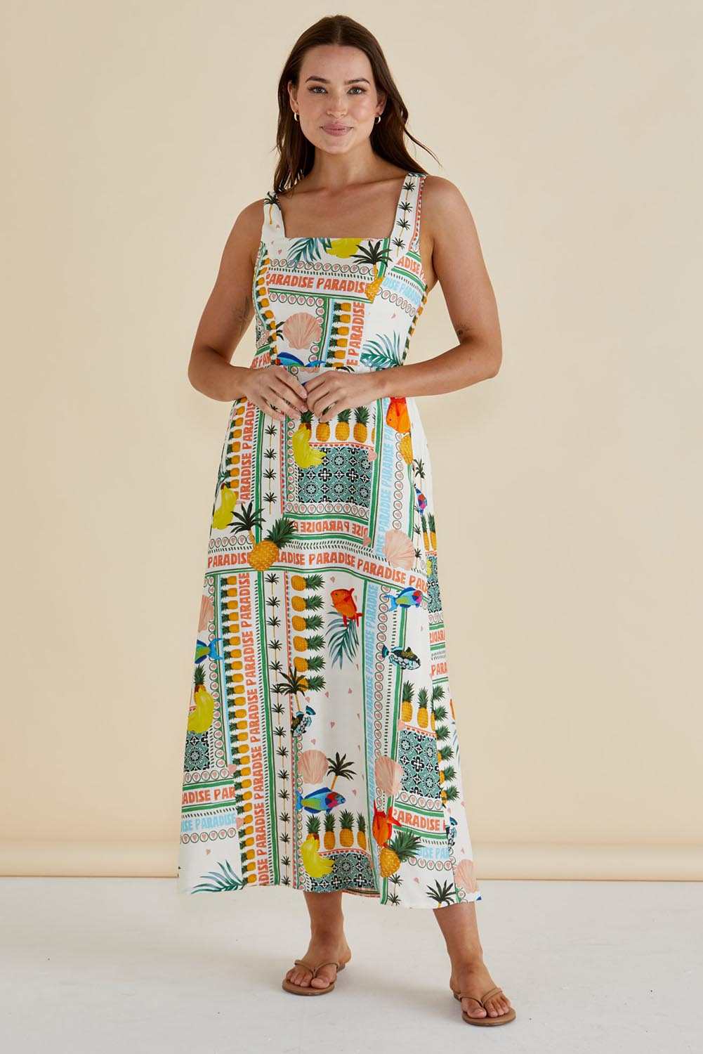 A model wearing the Tegan Midi Dress in colour Paradise, from the front, showing the whole outfit