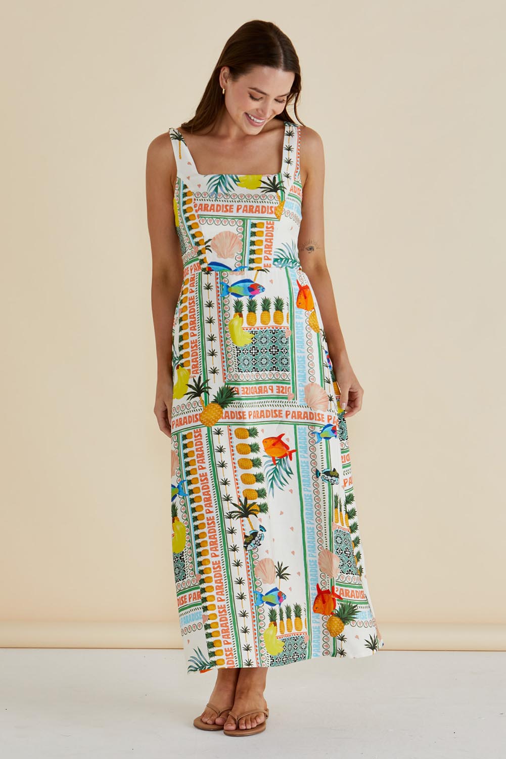 A model wearing the Tegan Midi Dress in colour Paradise, from the front, showing the whole outfit