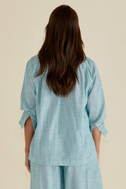 A model wearing the Charli Cotton Blouse in colour Green (Green), from the back