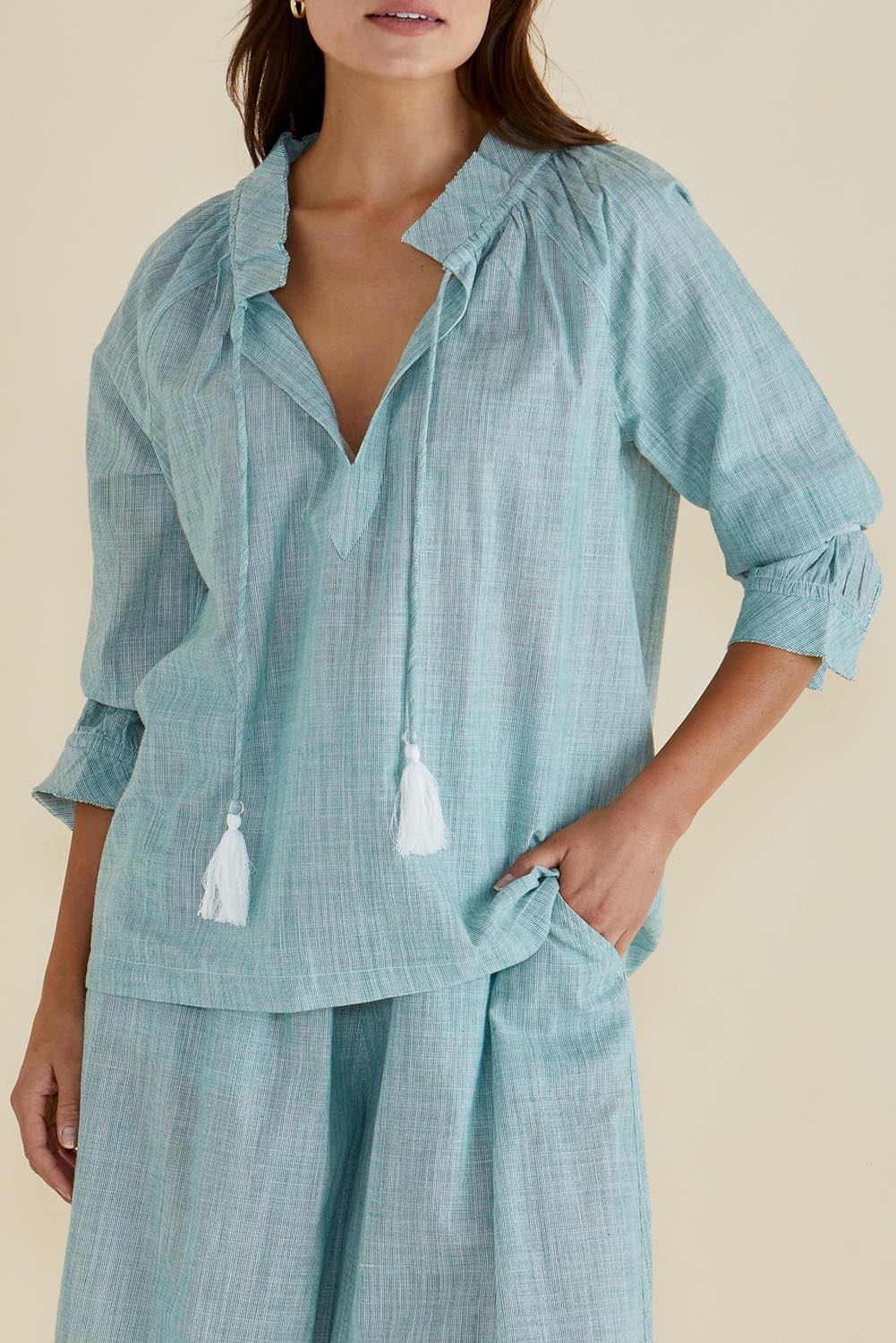 A model wearing the Charli Cotton Blouse in colour Green (Green), from the front, cropped image