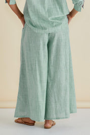 A model wearing the Tatum Cotton Wide Leg Pant in colour Green (Green), from the back