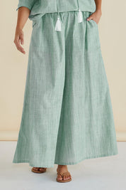 A model wearing the Tatum Cotton Wide Leg Pant in colour Green (Green), from the front, cropped image