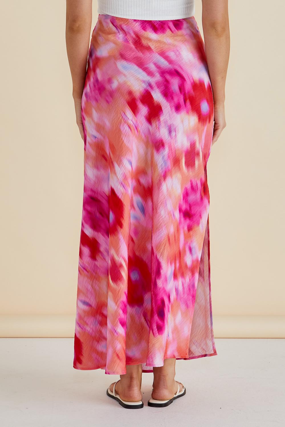 A model wearing the Mindy Skirt in colour Floral (Pink), from the back