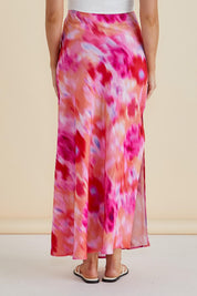 A model wearing the Mindy Skirt in colour Floral (Pink), from the back