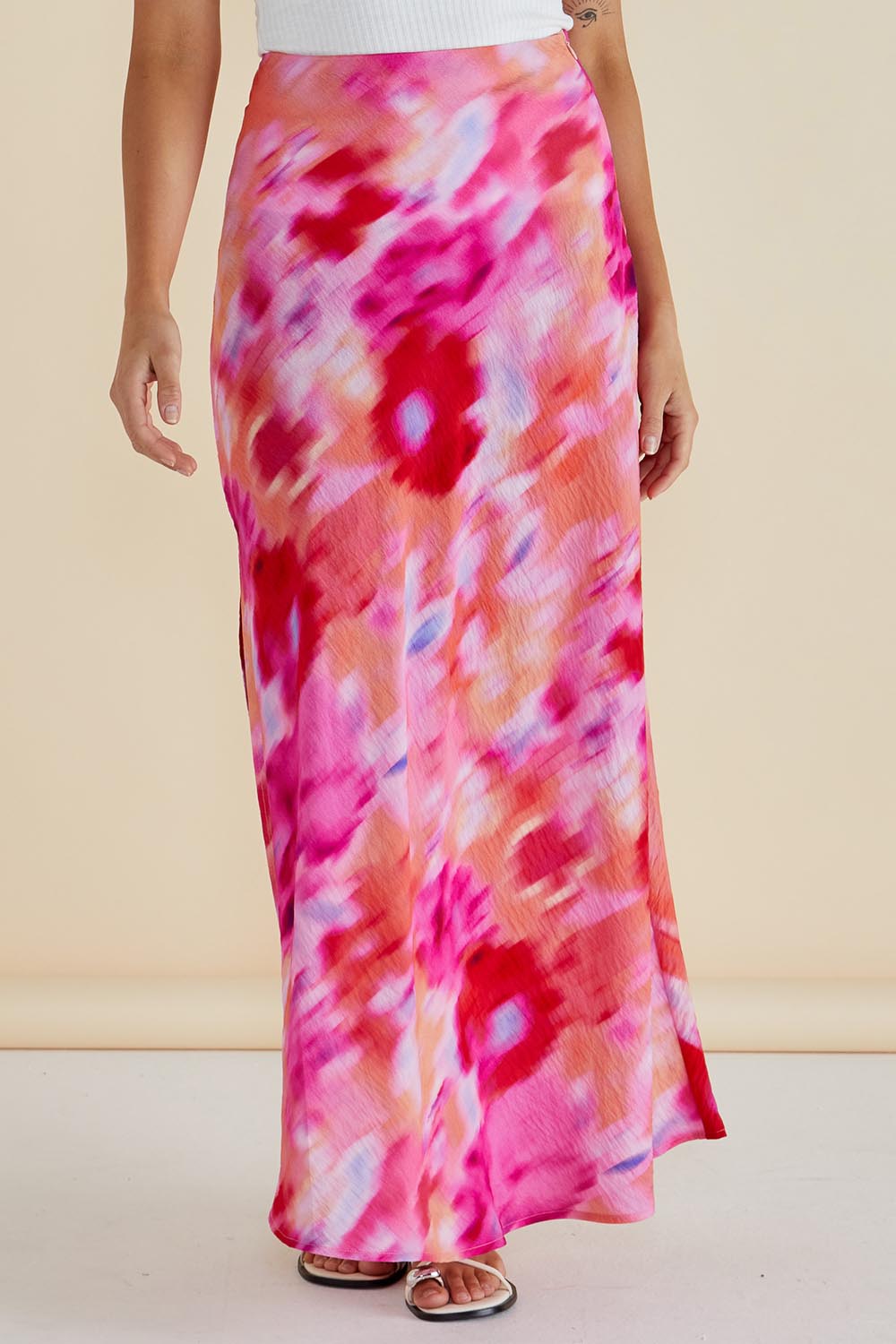 A model wearing the Mindy Skirt in colour Floral (Pink), from the front, cropped image