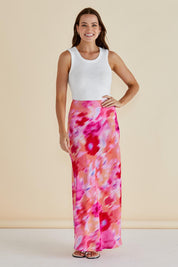 A model wearing the Mindy Skirt in colour Floral (Pink), from the front, showing the whole outfit
