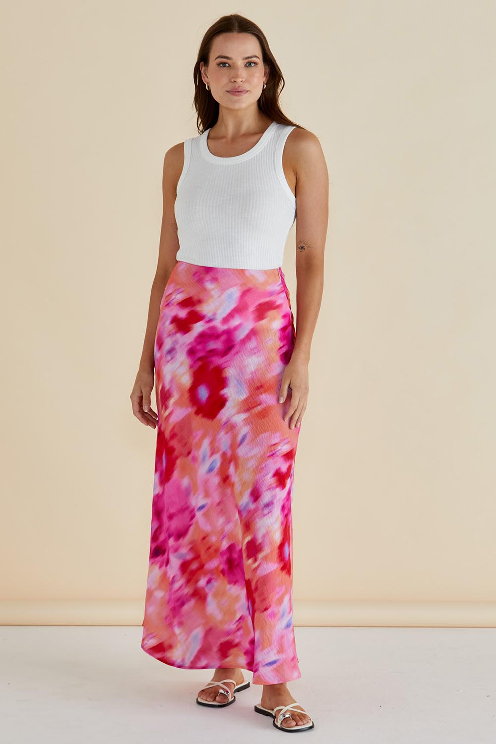 A model wearing the Mindy Skirt in colour Floral (Pink), from the front, showing the whole outfit