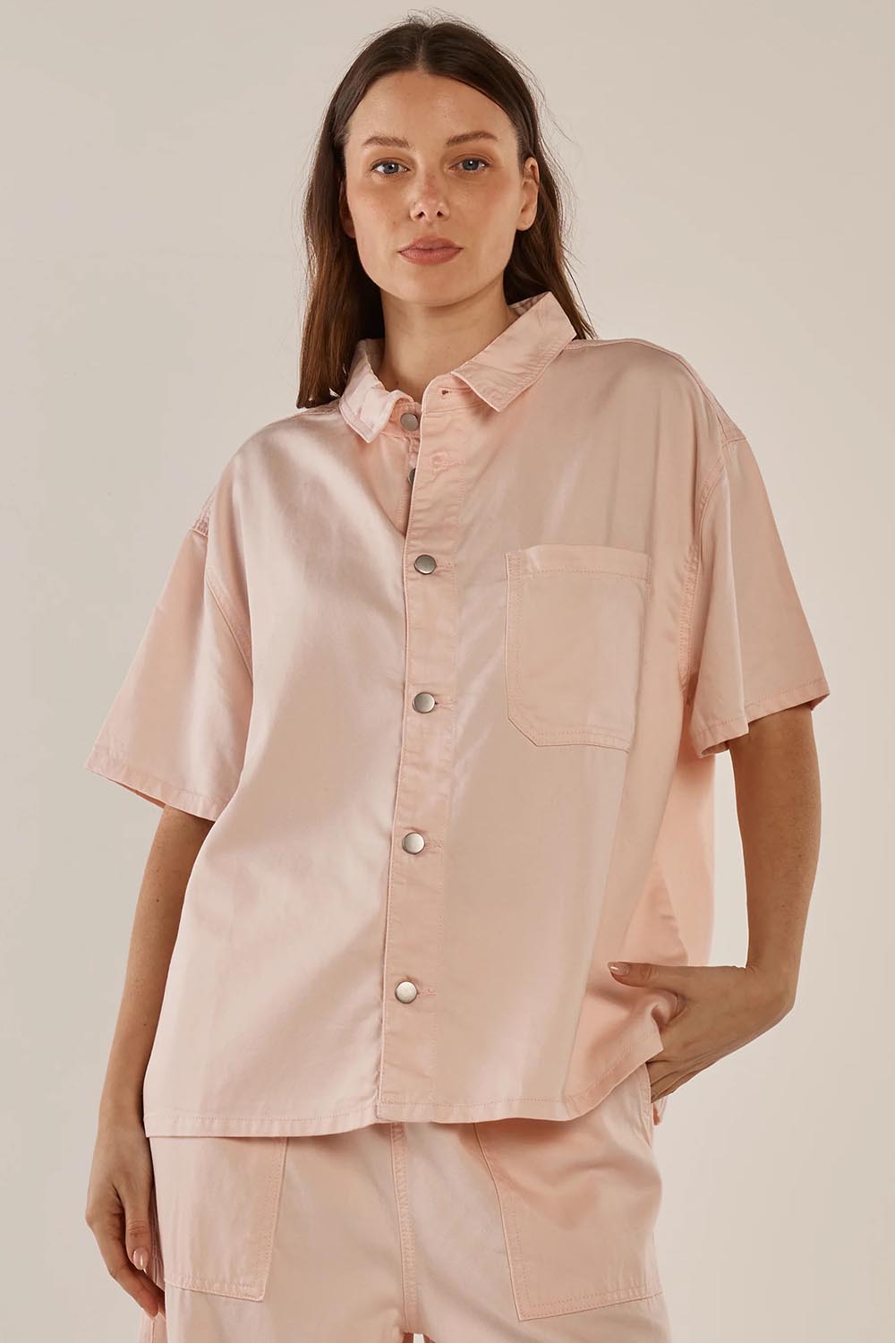 A model wearing the Saffra Short Sleeve Denim Shirt in colour Pink (Pink), from the front, cropped image