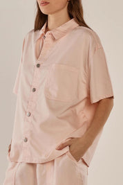 A model wearing the Saffra Short Sleeve Denim Shirt in colour Pink (Pink), from the front, cropped image