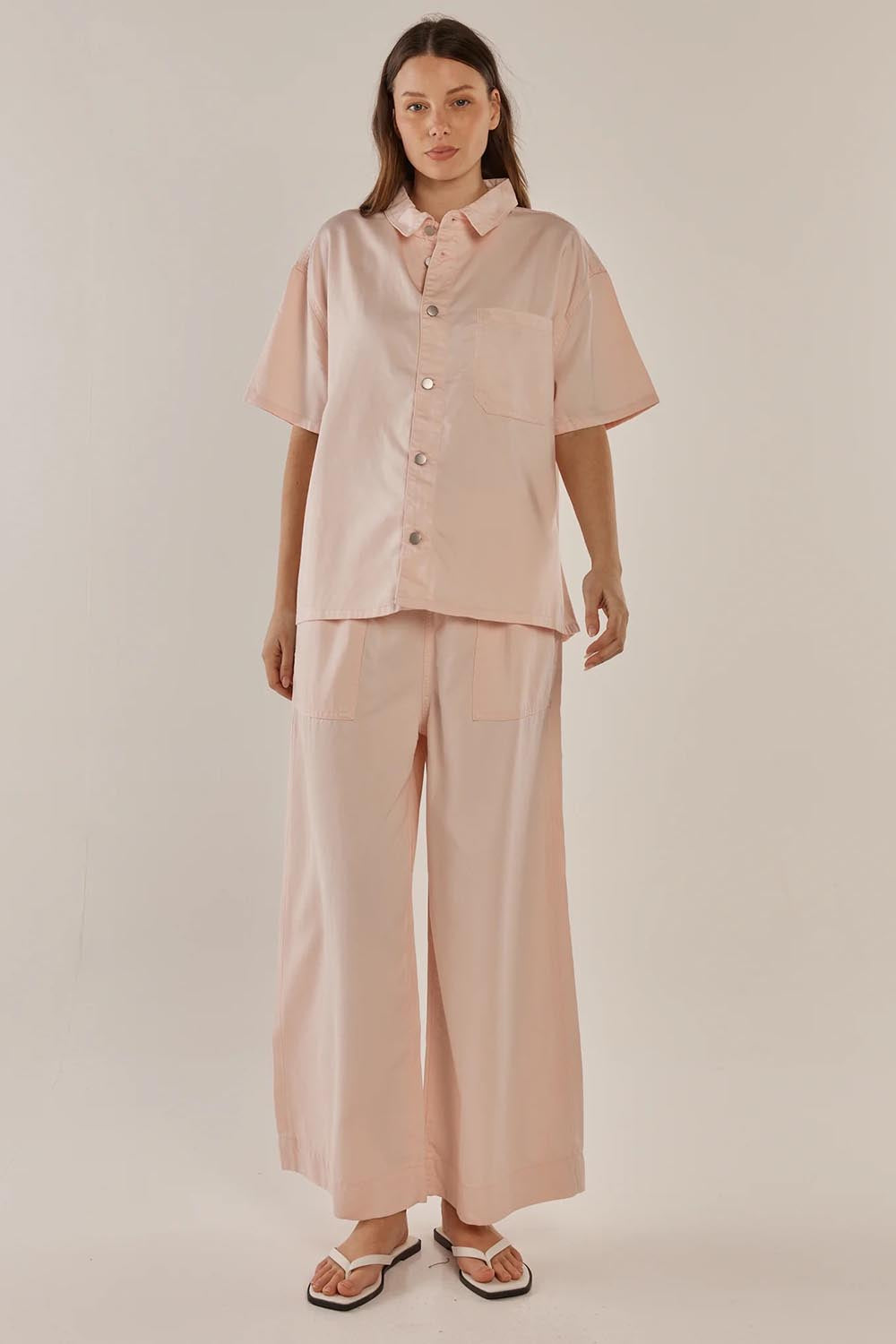 A model wearing the Saffra Short Sleeve Denim Shirt in colour Pink (Pink), from the front, showing the whole outfit