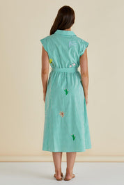 A model wearing the Gloria Floral Cotton Dress in colour Green (Green), from the back